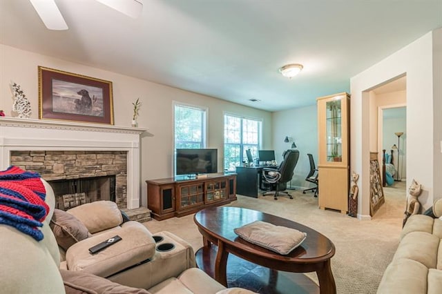 living room with light carpet and a fireplace