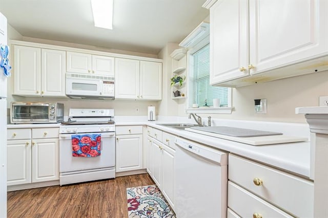 kitchen featuring white cabinetry, sink, white appliances, and dark wood-type flooring