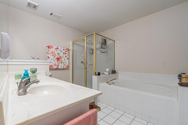 bathroom with tile patterned flooring, vanity, and separate shower and tub