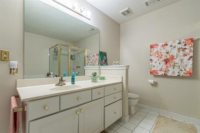 bathroom with tile patterned floors, toilet, a shower with door, and vanity