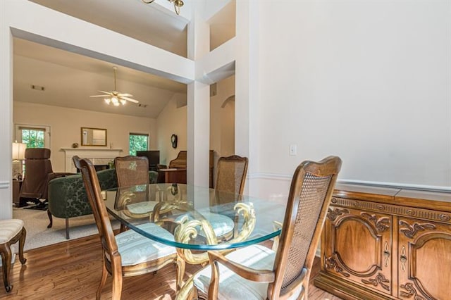 dining area with lofted ceiling, hardwood / wood-style flooring, and ceiling fan