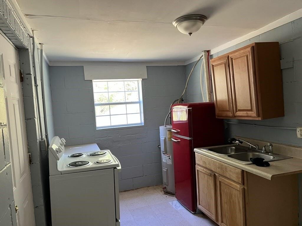 kitchen with light tile patterned floors, white electric range, refrigerator, water heater, and sink