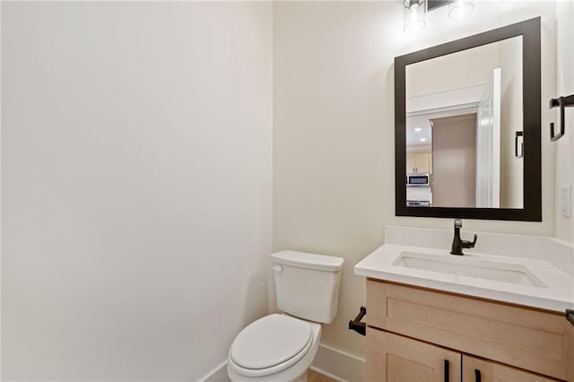 bathroom featuring toilet and vanity