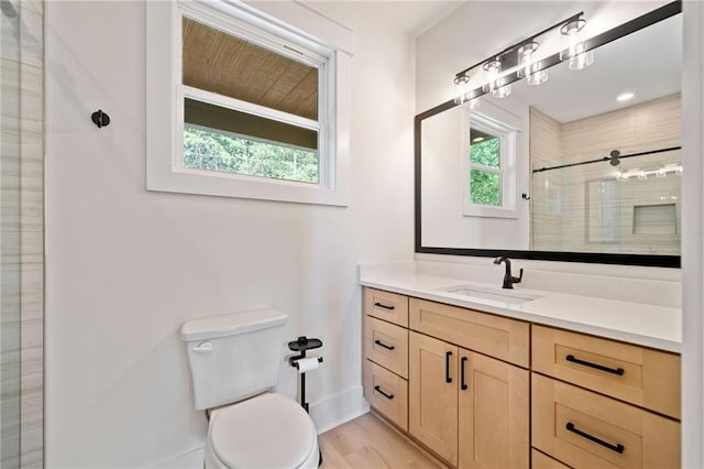 bathroom with a shower with shower door, wood-type flooring, toilet, and vanity