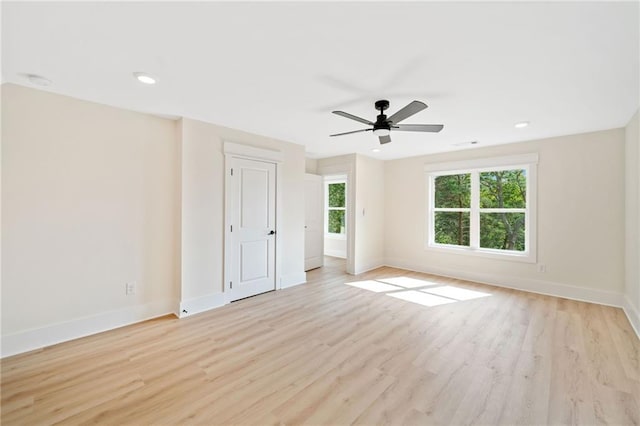 empty room featuring ceiling fan and light hardwood / wood-style floors