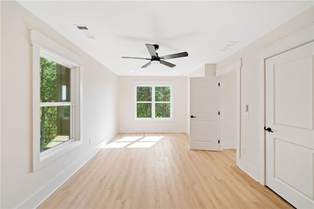 unfurnished room featuring ceiling fan, plenty of natural light, and light hardwood / wood-style flooring