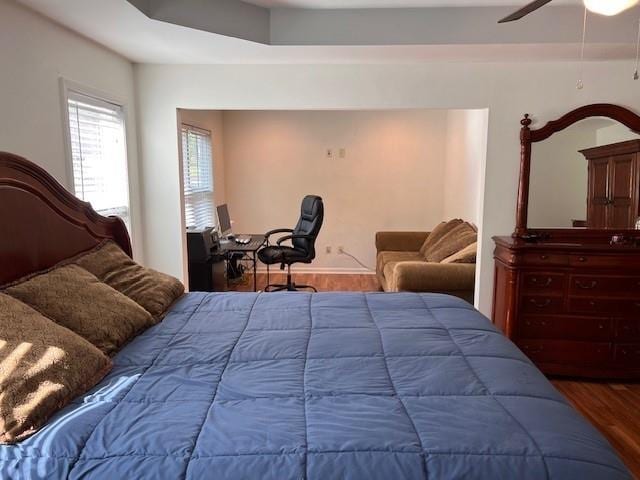 bedroom with wood-type flooring and ceiling fan