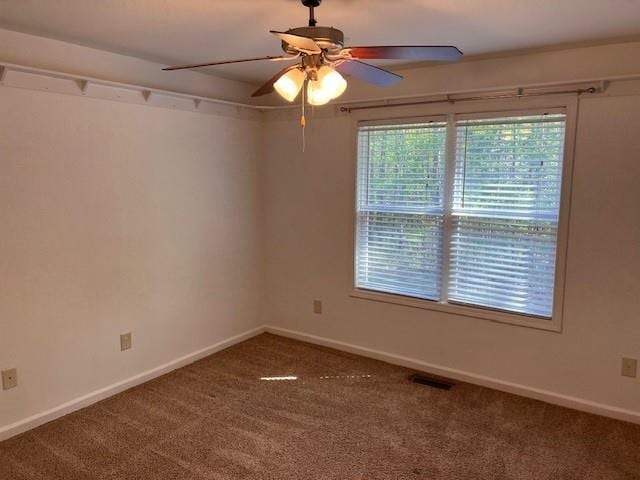 carpeted spare room with ceiling fan