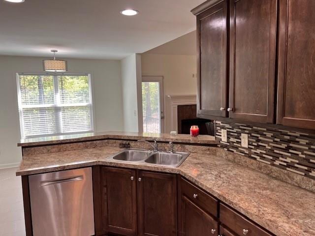 kitchen with tasteful backsplash, sink, dark brown cabinetry, decorative light fixtures, and stainless steel dishwasher