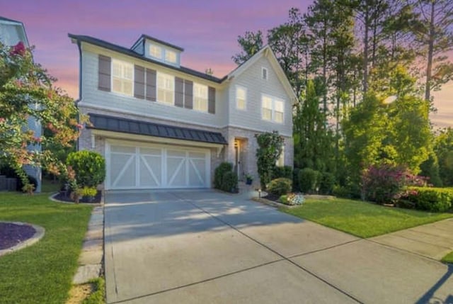 view of property featuring a yard and a garage