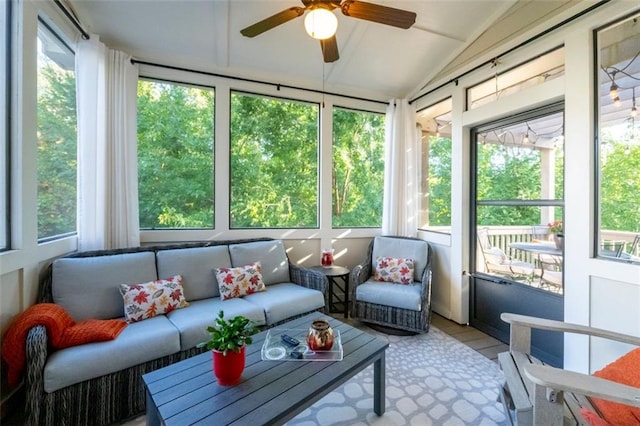 sunroom / solarium with ceiling fan and vaulted ceiling