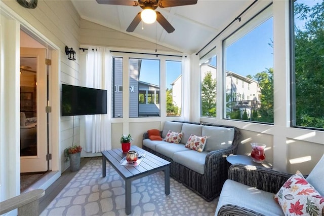 sunroom featuring vaulted ceiling, a healthy amount of sunlight, and ceiling fan