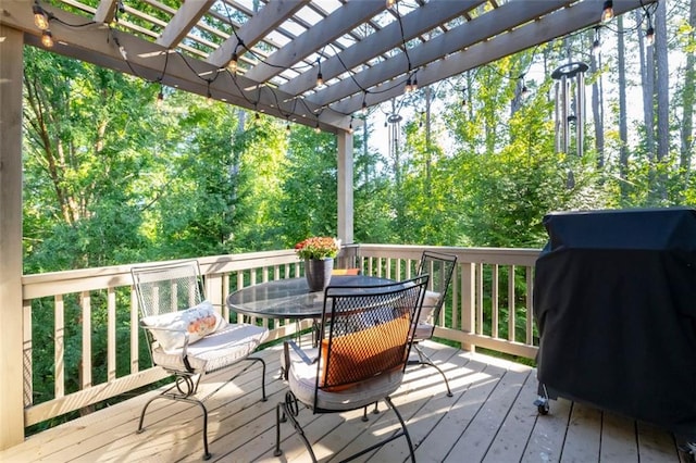 deck featuring area for grilling and a pergola