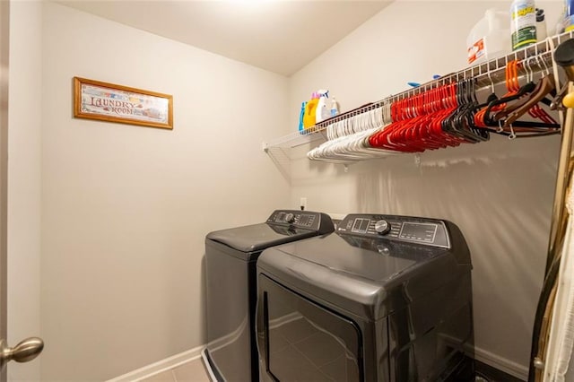 laundry room with tile patterned floors and washer and clothes dryer