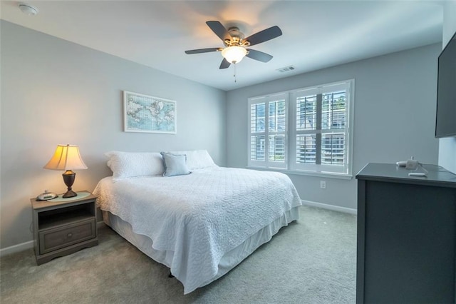 bedroom featuring light carpet and ceiling fan