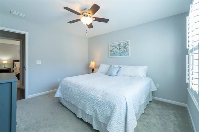 bedroom featuring light carpet and ceiling fan