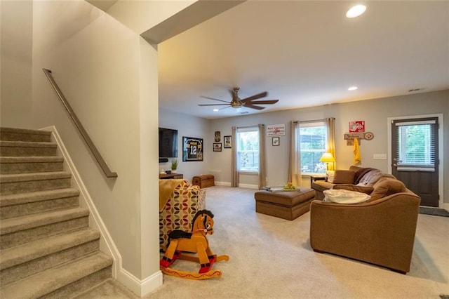 living room with light carpet and ceiling fan