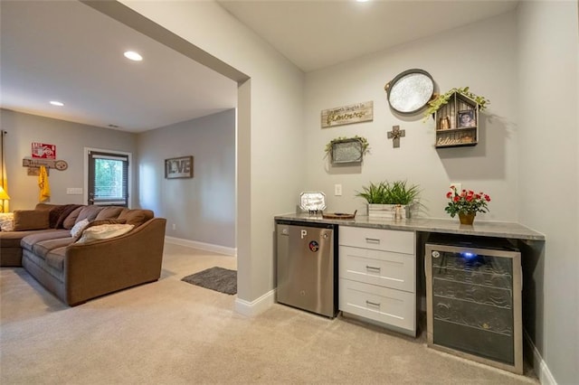 bar featuring wine cooler, white cabinetry, light carpet, stainless steel fridge, and light stone countertops