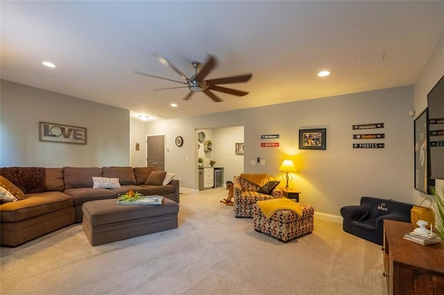 living room with ceiling fan and light colored carpet