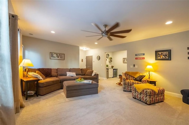 living room featuring light colored carpet and ceiling fan