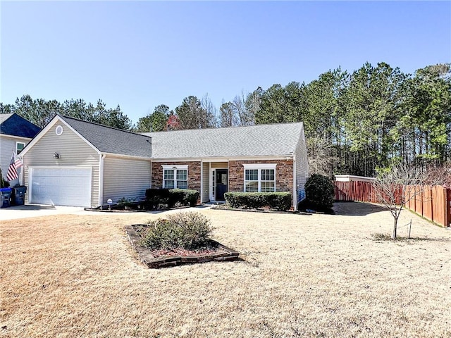 ranch-style house with an attached garage, fence, and driveway