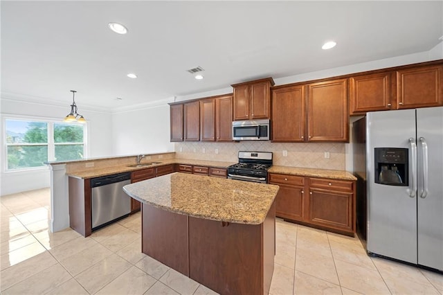 kitchen featuring sink, hanging light fixtures, kitchen peninsula, appliances with stainless steel finishes, and ornamental molding