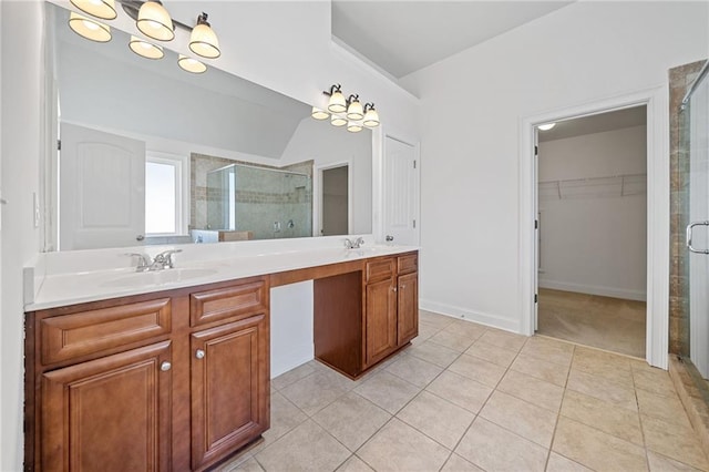 bathroom featuring tile patterned floors, a shower with door, vanity, and vaulted ceiling