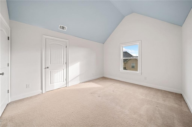 bonus room featuring light colored carpet and lofted ceiling