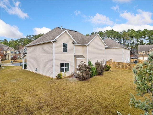 rear view of property featuring a yard