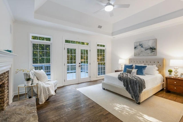 bedroom featuring dark wood-type flooring, ceiling fan, french doors, and access to exterior