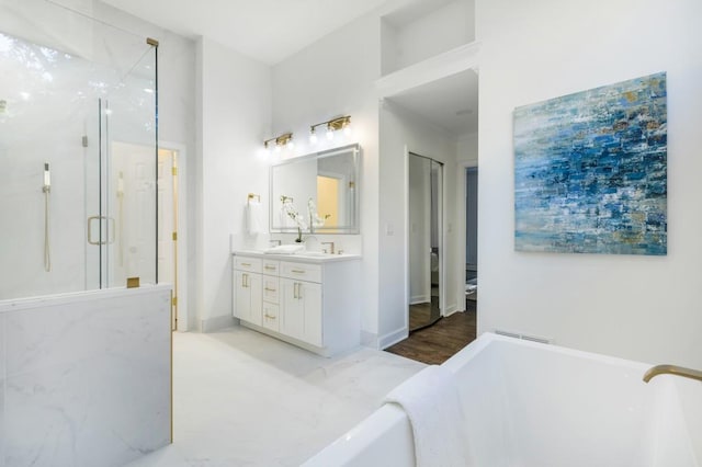 bathroom featuring vanity, hardwood / wood-style floors, and separate shower and tub