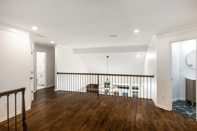 corridor with ornamental molding, vaulted ceiling, and dark hardwood / wood-style flooring