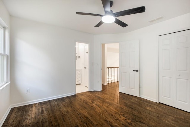 unfurnished bedroom with a closet, ceiling fan, and dark hardwood / wood-style flooring