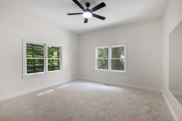 carpeted empty room with ceiling fan