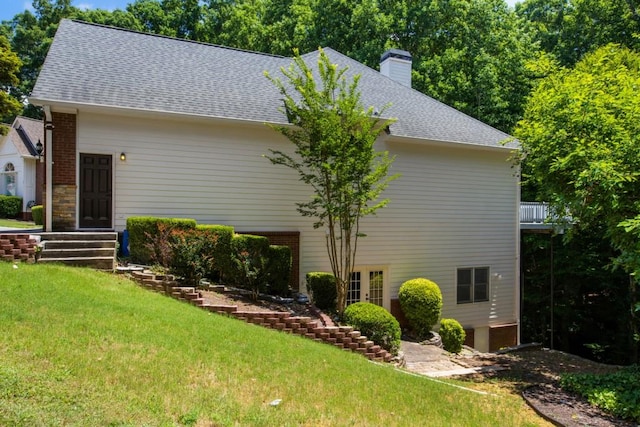 view of property exterior with a balcony and a yard