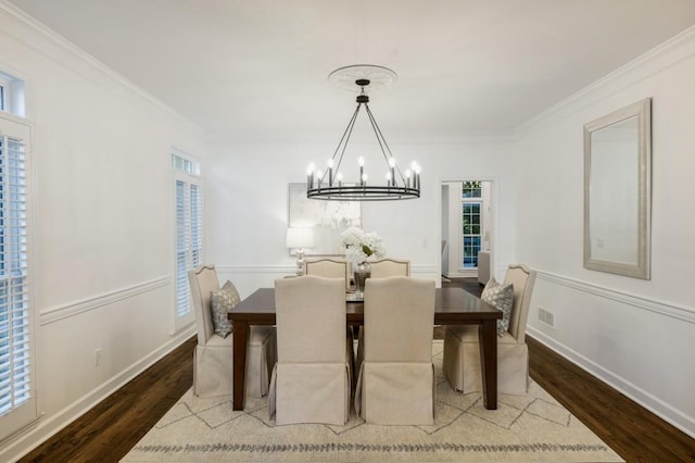 dining space with crown molding, a chandelier, and hardwood / wood-style floors