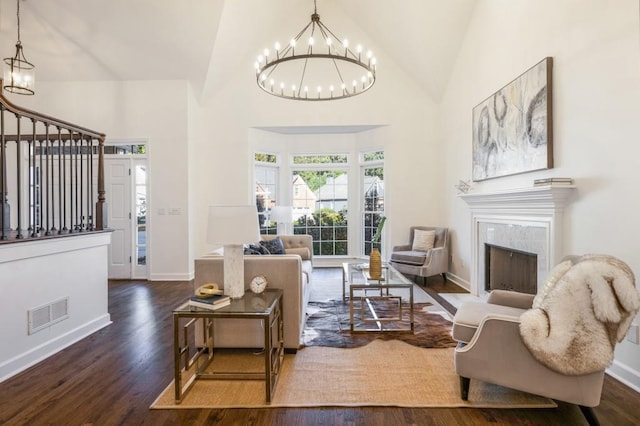 living room featuring a fireplace, dark hardwood / wood-style floors, and high vaulted ceiling