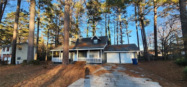 view of front of home with covered porch and a garage