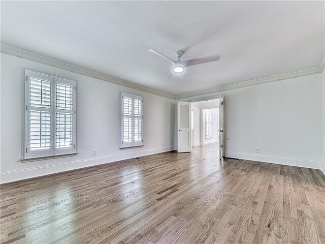 unfurnished room with hardwood / wood-style floors, ceiling fan, and ornamental molding