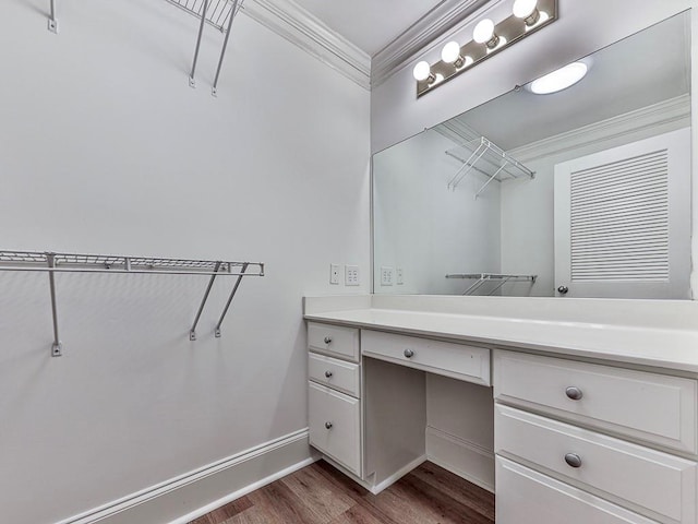 bathroom featuring hardwood / wood-style floors, vanity, and ornamental molding