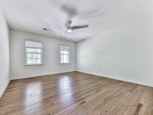 empty room with ceiling fan and light wood-type flooring