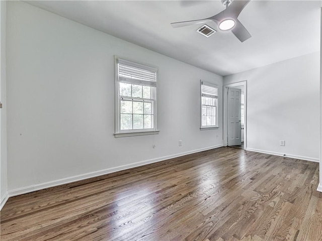 unfurnished room with ceiling fan and hardwood / wood-style flooring