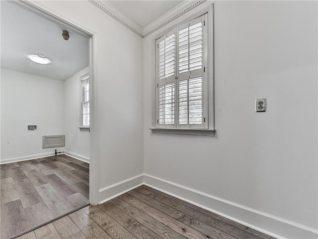 unfurnished room featuring a healthy amount of sunlight, crown molding, and light hardwood / wood-style flooring