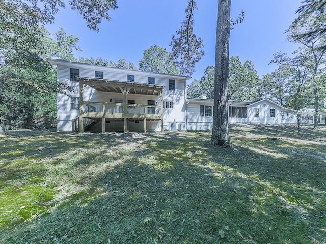 back of house with central AC unit, a yard, and a wooden deck