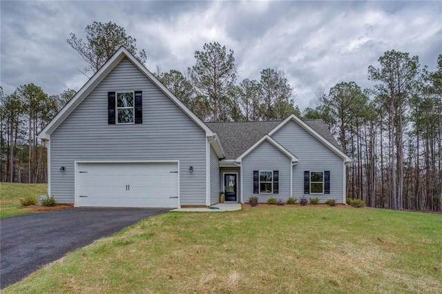 view of front of house featuring aphalt driveway, a front yard, a shingled roof, and an attached garage