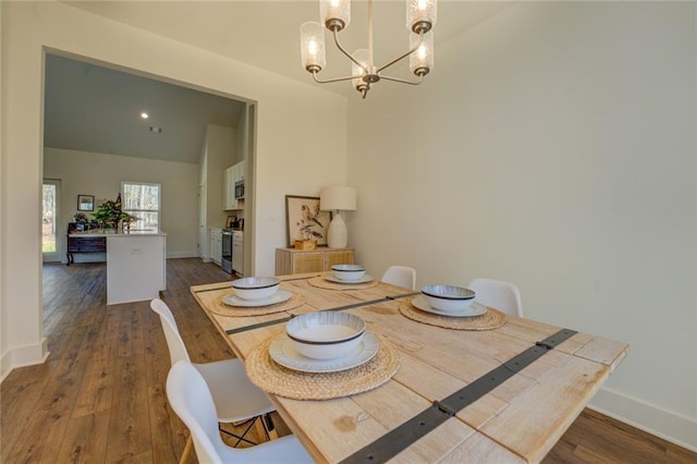 dining room featuring high vaulted ceiling, baseboards, a chandelier, and dark wood-type flooring