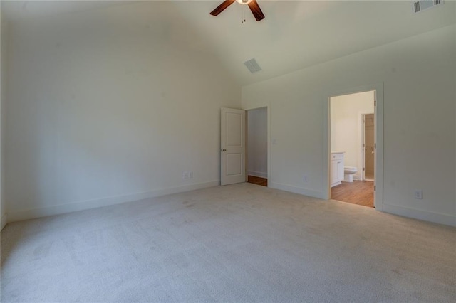 unfurnished bedroom featuring high vaulted ceiling, visible vents, light carpet, and baseboards