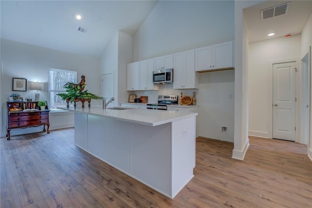 kitchen with visible vents, appliances with stainless steel finishes, white cabinets, and light countertops