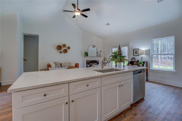 kitchen with visible vents, white cabinetry, open floor plan, light wood-type flooring, and dishwasher