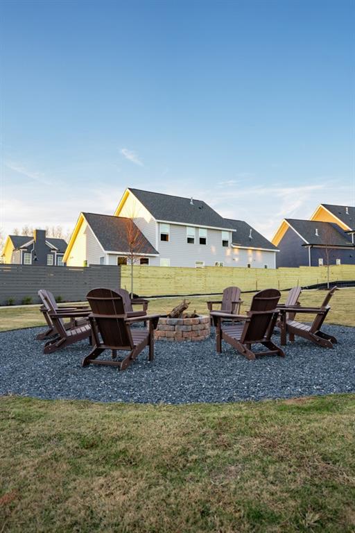 view of jungle gym with a fire pit and a lawn